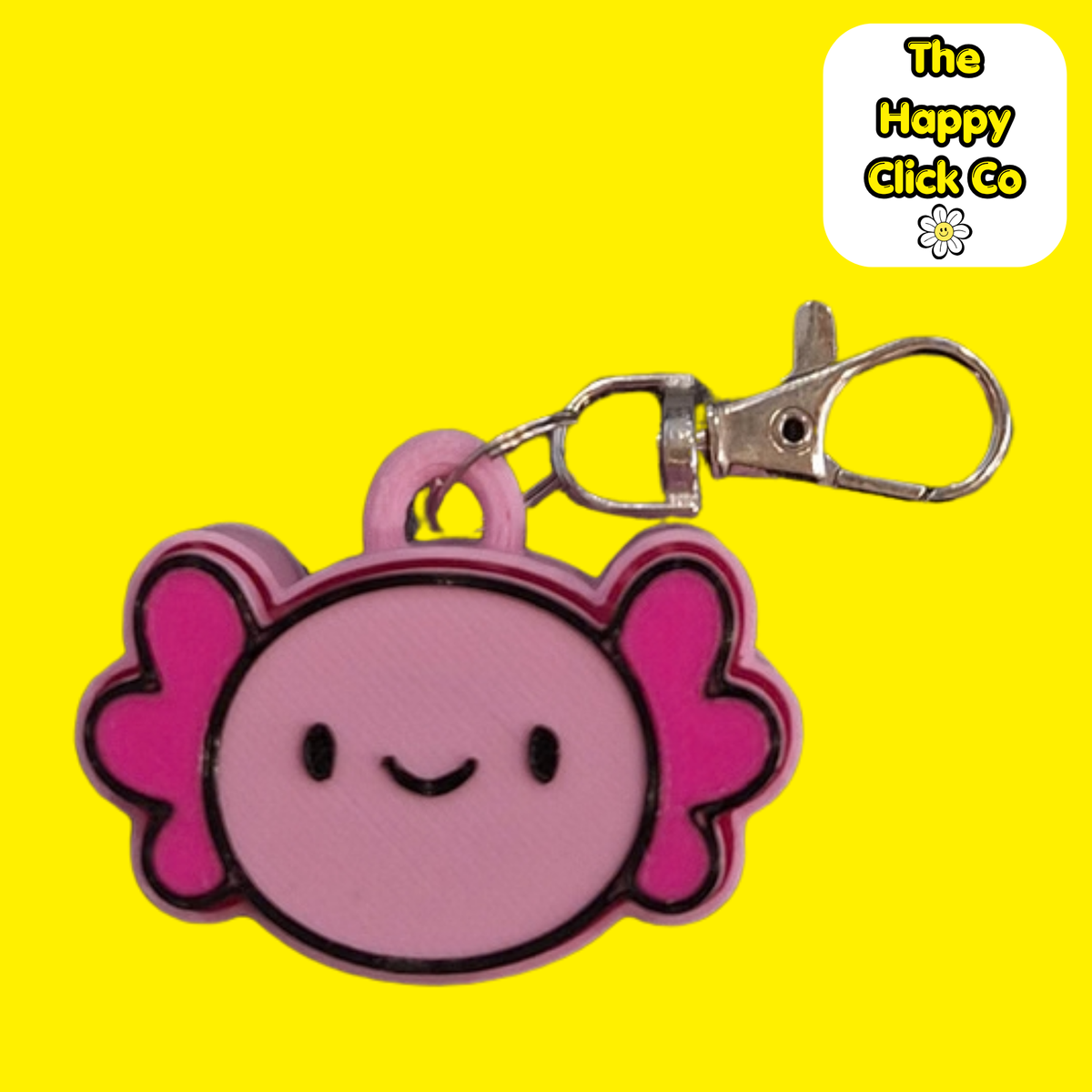 A pink and magenta cartoon axolotl fidget clicker keychain with a silver metal lobster clasp, shown against a solid bright yellow background. A white brand label in the top right corner reads 'The Happy Click Co'.